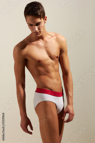 Strong handsome fitness sports man in underwear isolated