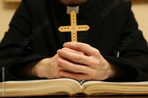 Priest reading from the holy bible, close up