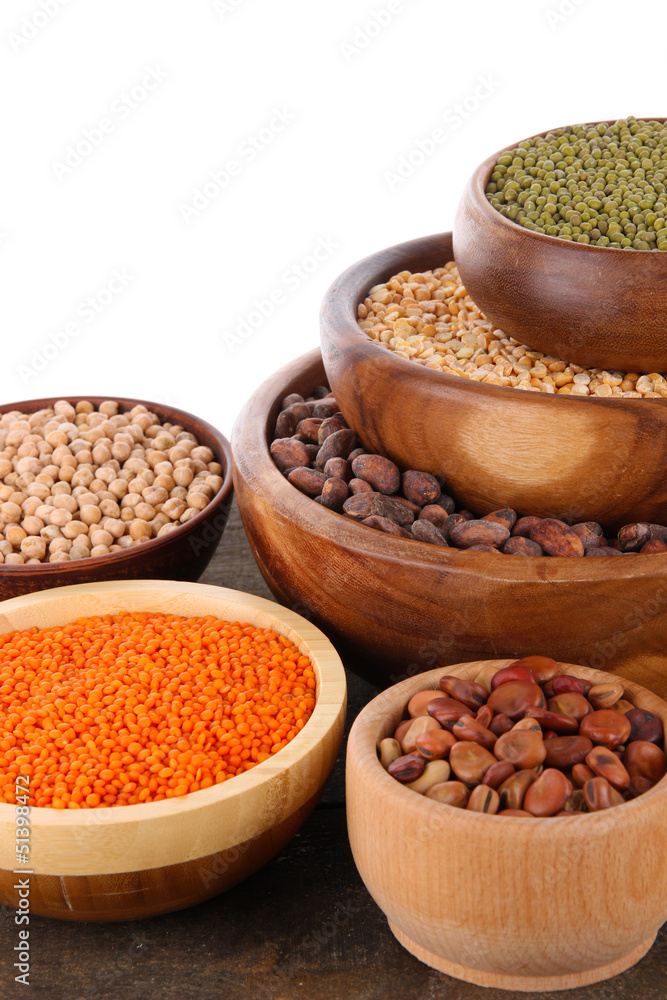 Different kinds of beans in bowls on table isolated on white Different kinds of beans in bowls on table isolated on white