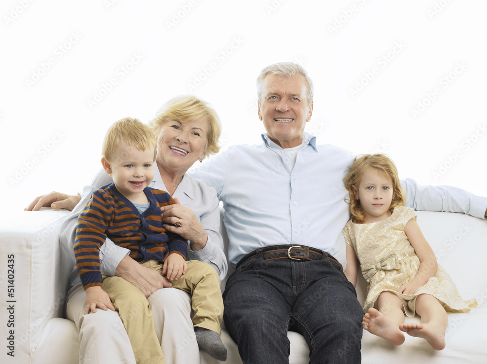 Portrait Of Grandparents And Grandchildren On Sofa