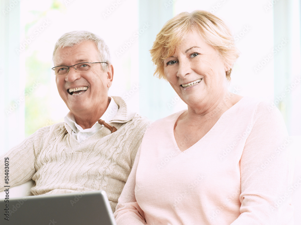 Close up of a senior happy couple in front of a laptop Close up of a senior happy couple in front of a laptop