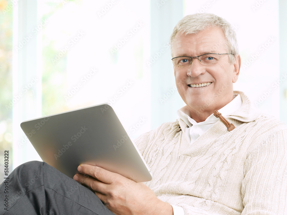 Senior man reading an e-book Senior man reading an e-book