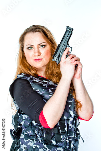 Young and beautiful woman with a gun