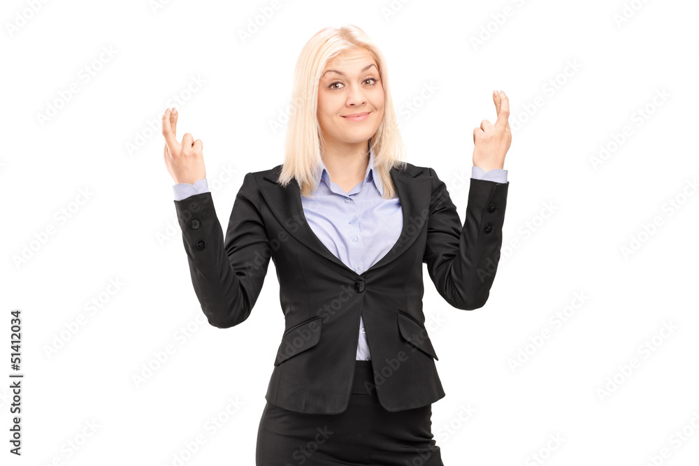 Young blond businesswoman posing with fingers crossed for luck Young blond businesswoman posing with fingers crossed for luck