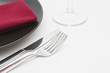 Black plate place setting with glass