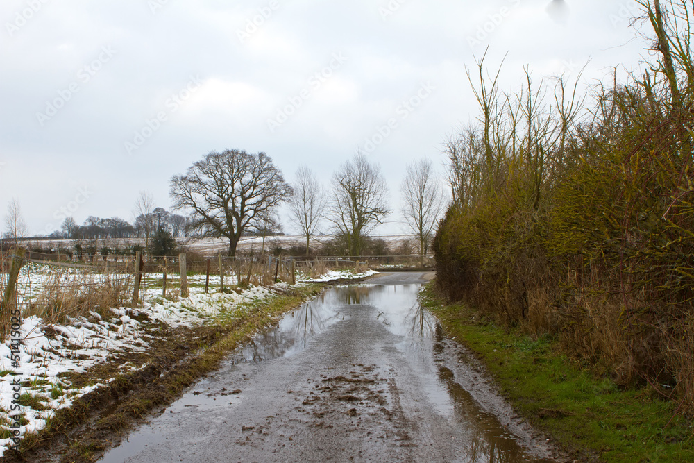rural road with low level winter flood water rural road with low level winter flood water