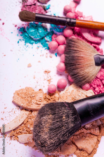 close up of a make up accessories-powder, eyeshadows, lipstick 