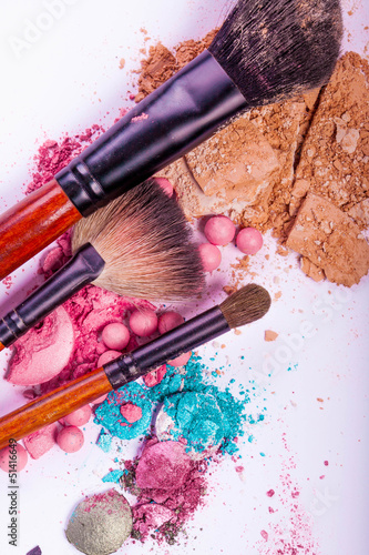 close up of a make up accessories-powder, eyeshadows, lipstick 