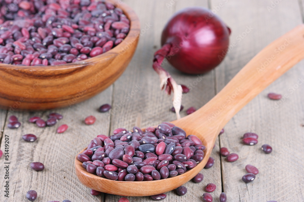Red beans and onion on a wooden background Red beans and onion on a wooden background