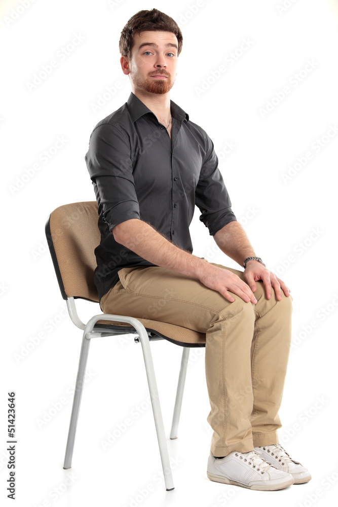 Young caucasian handsome man sitting on the chair