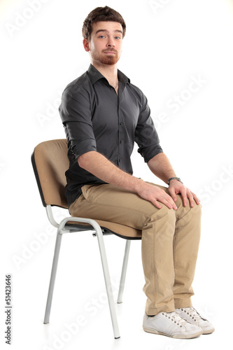 Young caucasian handsome man sitting on the chair