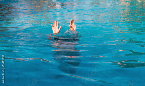 two hands of drowning man in pool