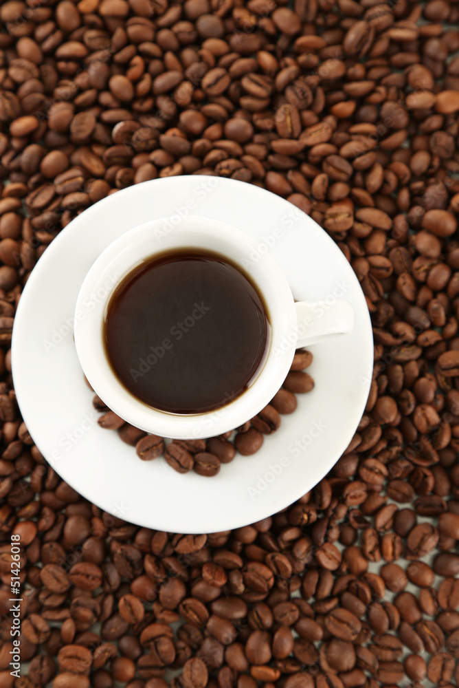 Cup of coffee on coffee beans background Cup of coffee on coffee beans background