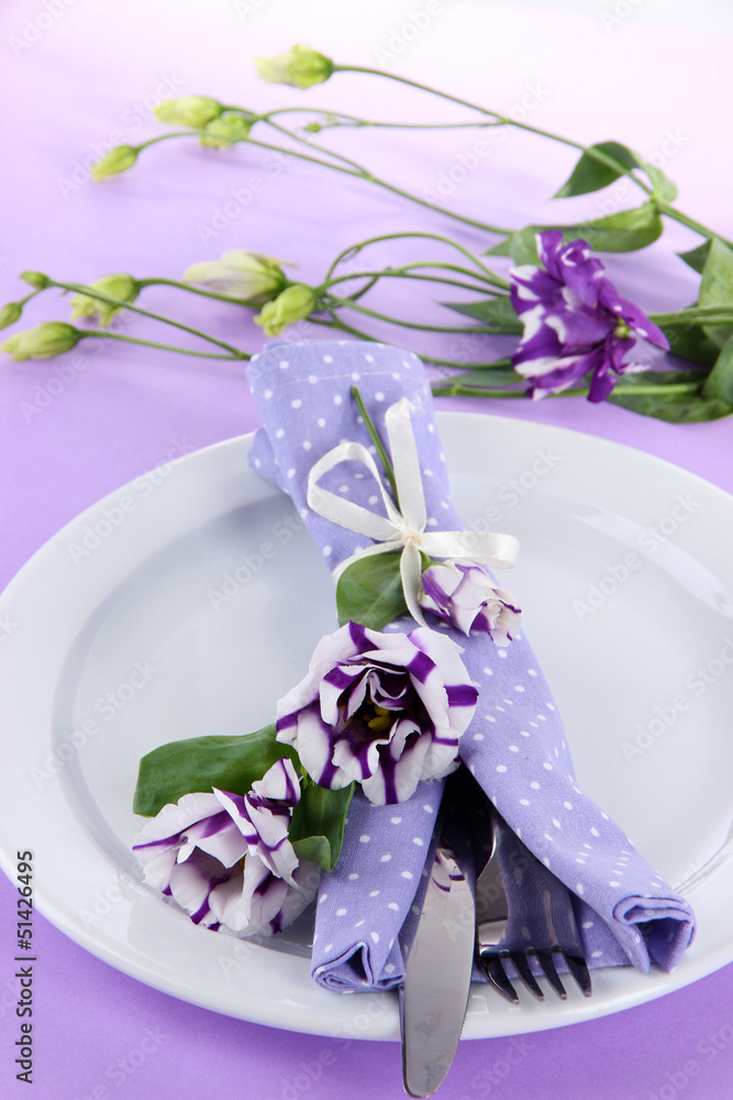 Served plate with napkin and flowers close-up Served plate with napkin and flowers close-up