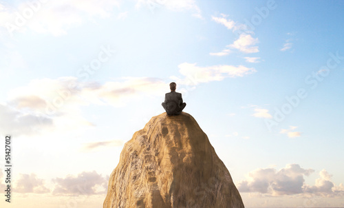 man sitting on peak