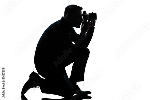 silhouette man kneeling photographer