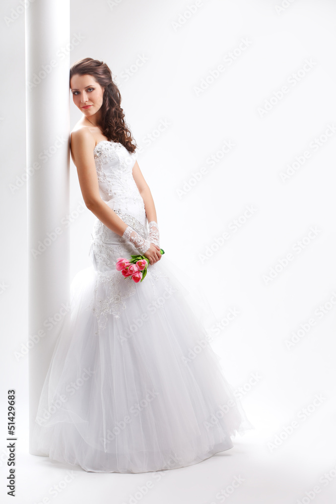 beautiful bride standing near white column beautiful bride standing near white column