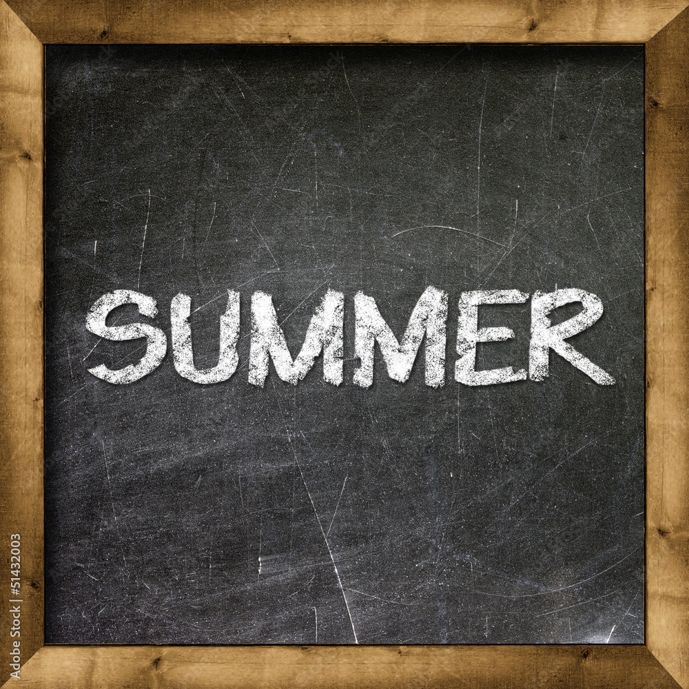 Fototapeta premium Summer handwritten with white chalk on a blackboard.