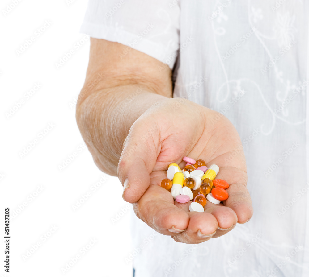 hand of the old woman with pills. isolated hand of the old woman with pills. isolated