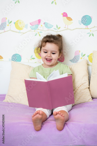 cute happy little girl read...