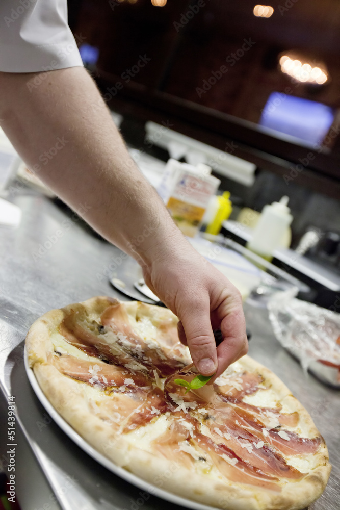 chef making pizza at kitchen 