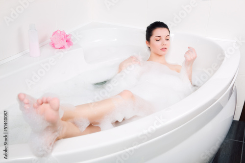 beautiful young woman takes bubble bath