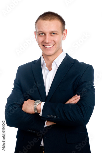 Portrait of a smiling young businessman standing against