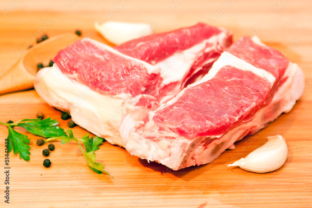 Raw beef with spices and vegetables on the cutting board