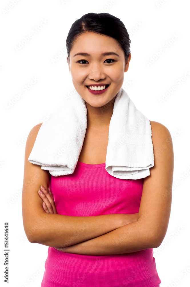 Fit smiling woman with towel around her neck Fit smiling woman with towel around her neck