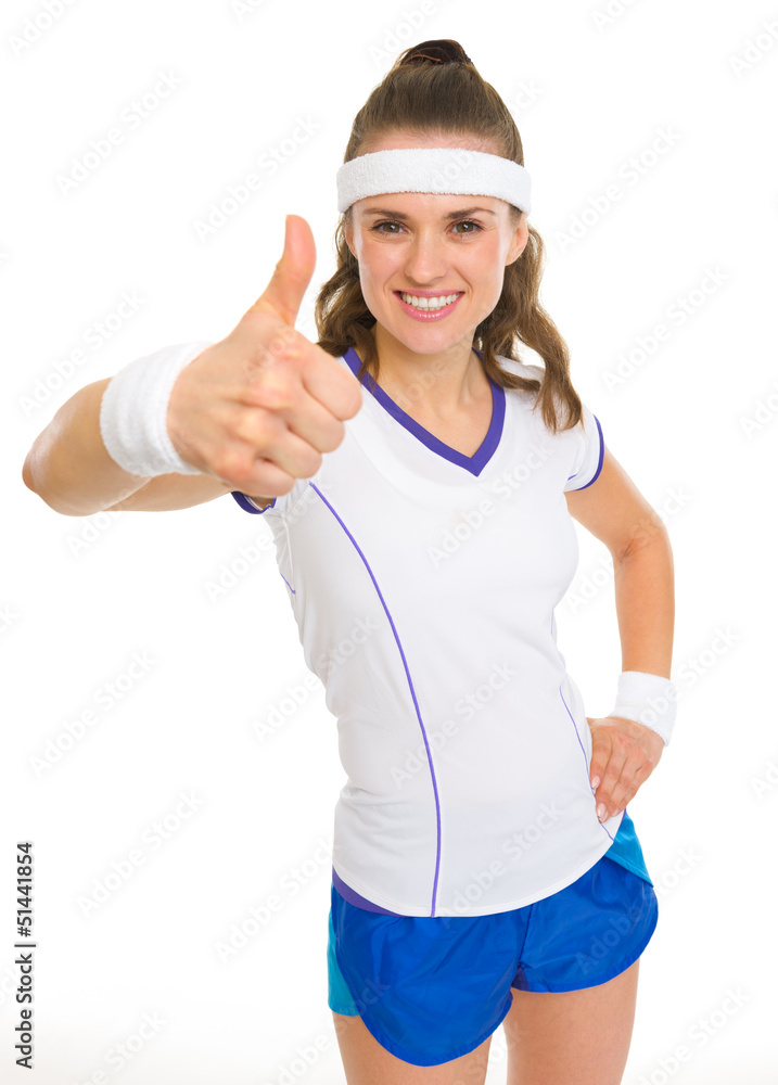 Smiling female tennis player showing thumbs up Smiling female tennis player showing thumbs up
