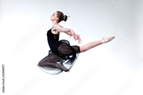 Beautiful ballet-dancer, modern style dancer posing on studio photo