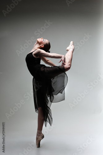 Beautiful ballet-dancer, modern style dancer posing on studio
