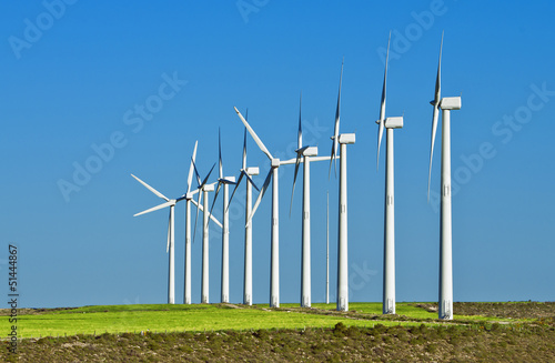 field of wind generators against blue sky