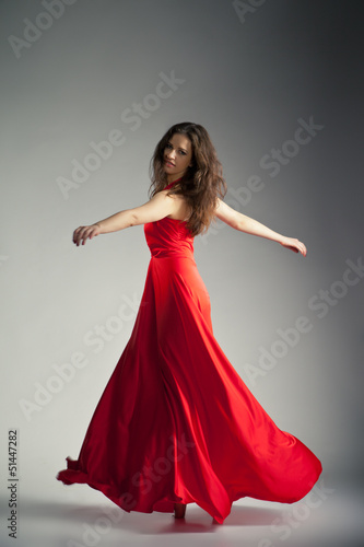 Ballet dancer wearing red dress over grey