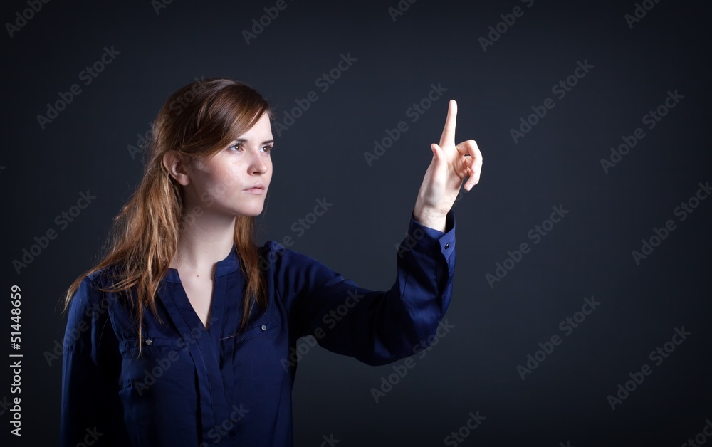 Woman's hand with finger, dark background
