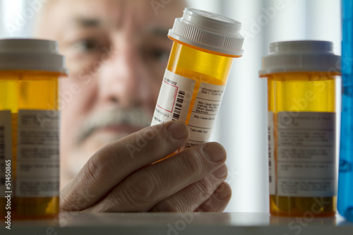 Man reaching for prescription form medicine cabinet photo