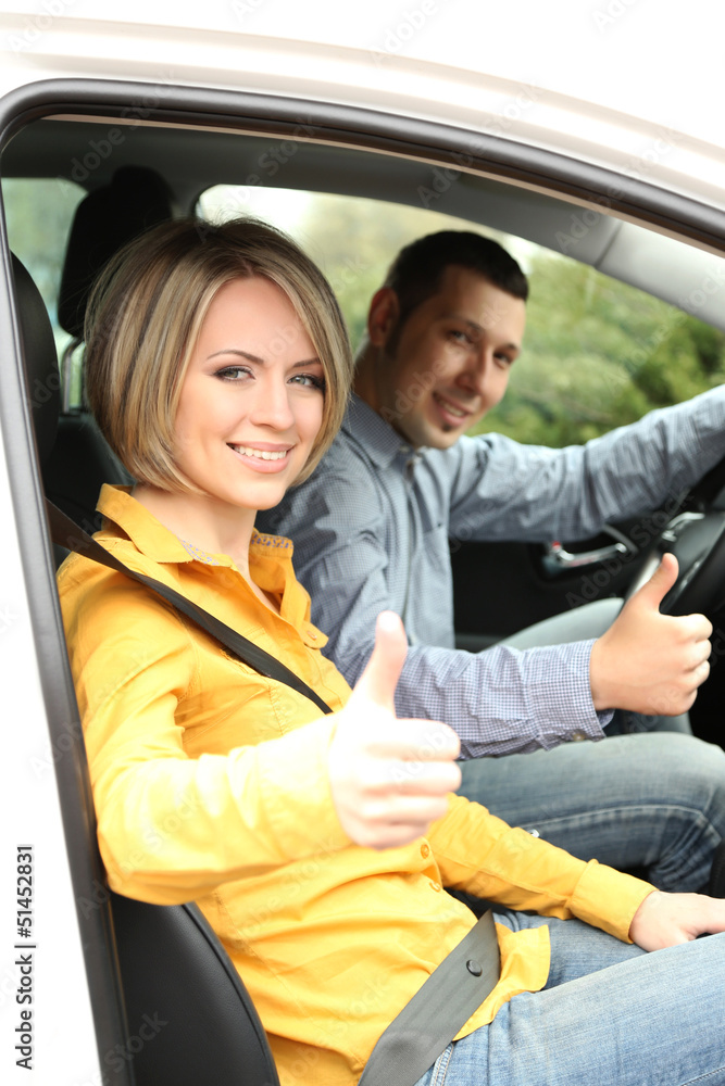 Portrait of young beautiful couple sitting in the car Portrait of young beautiful couple sitting in the car
