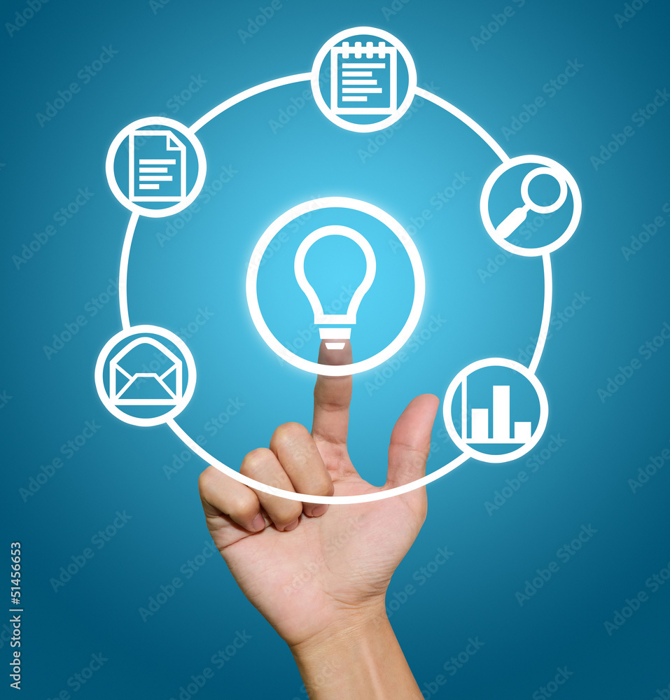 Hand pointing to business icons Hand pointing to business icons