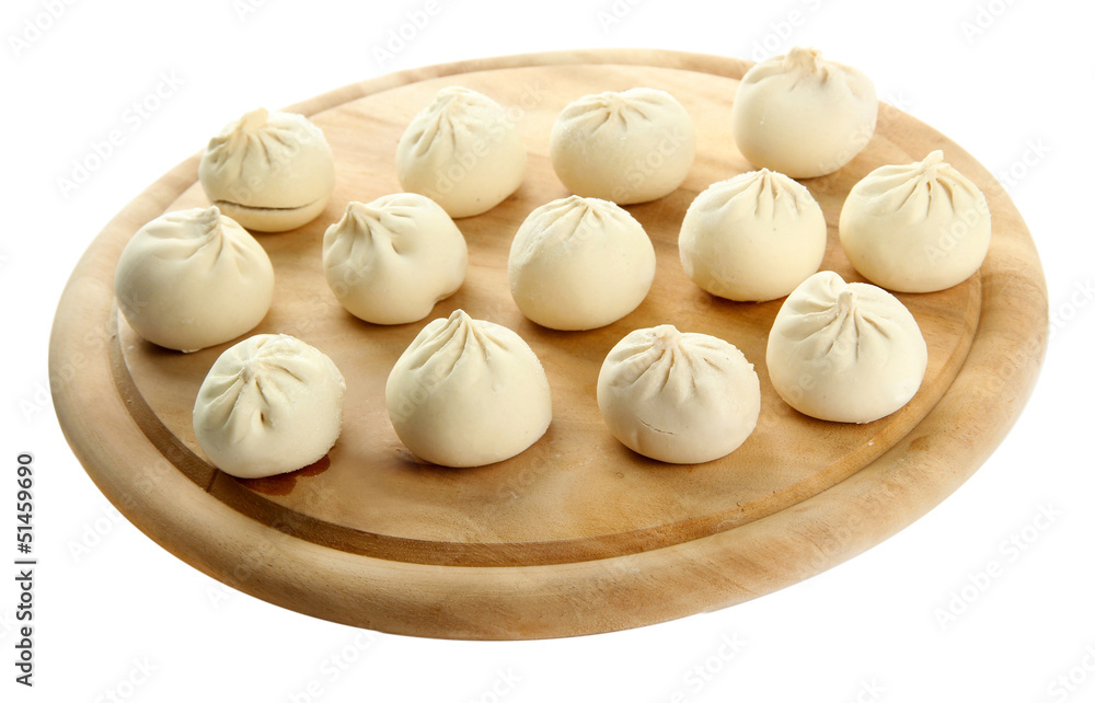 Raw khinkali on wooden desk, isolated on white Raw khinkali on wooden desk, isolated on white