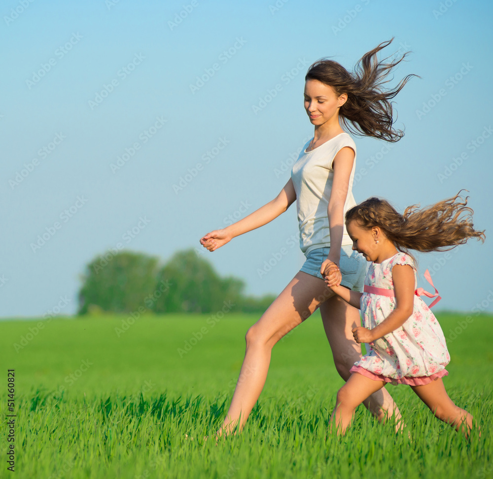 Young happy girls running at green wheat field Young happy girls running at green wheat field