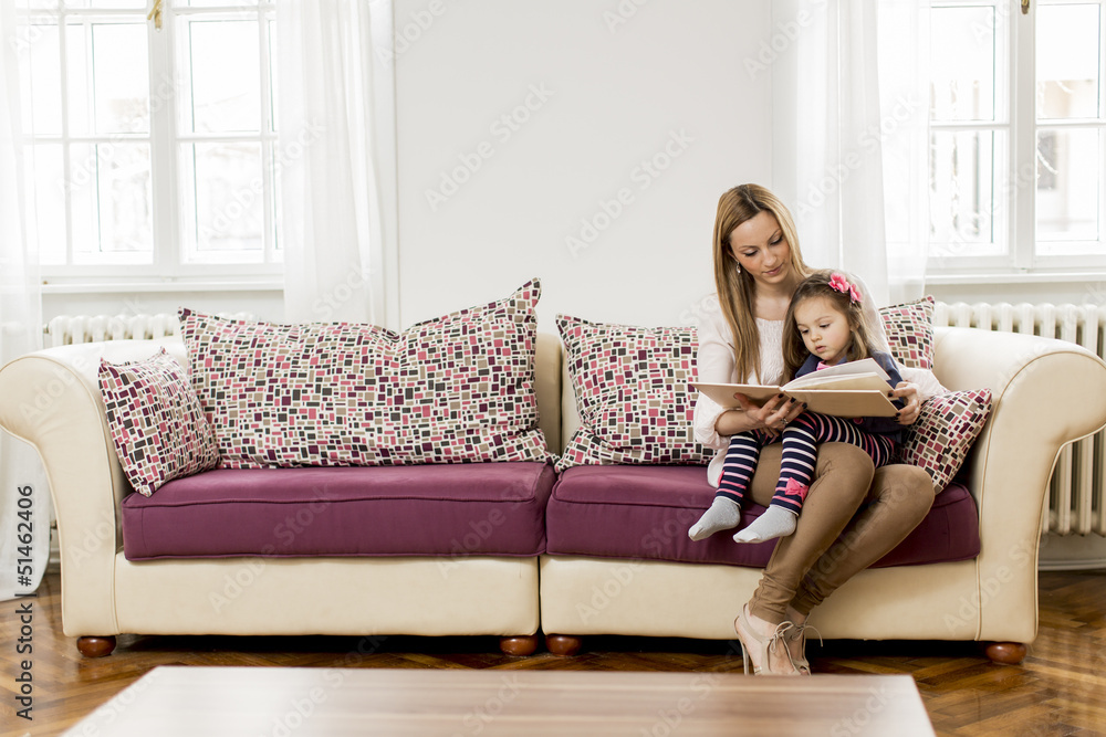 Mother and daughter reading in the room Mother and daughter reading in the room