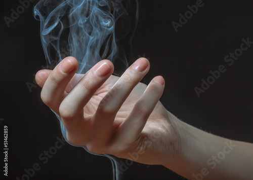 Through a palm passes a smoke