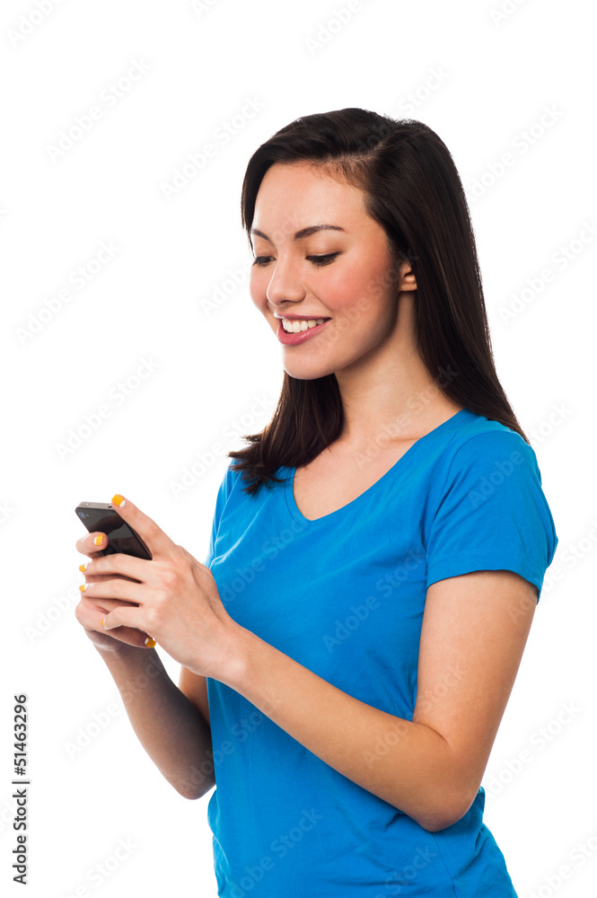 Pretty girl sending text message to her boyfriend Pretty girl sending text message to her boyfriend