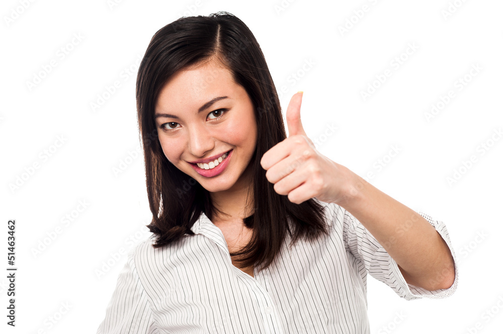 Smiling young woman showing thumbs up Smiling young woman showing thumbs up