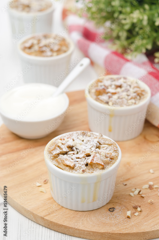 apple pie with nuts in a white ramekin apple pie with nuts in a white ramekin