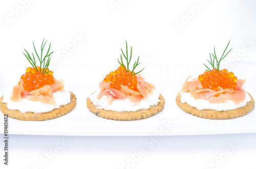 appetizer crackers with cream cheese, salted salmon and caviar
