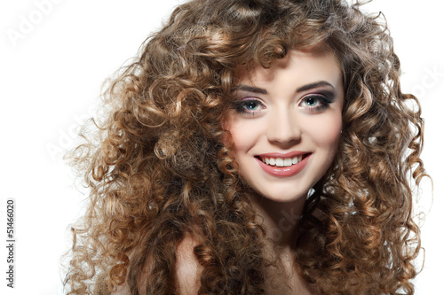 Young beautiful woman with long curly hairs on a white 