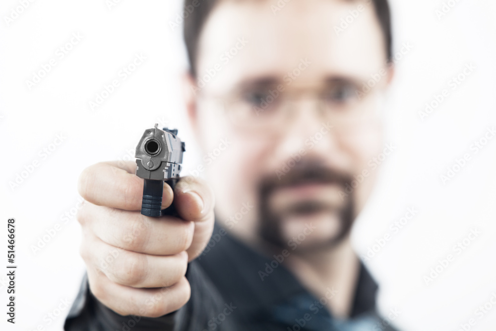 Fototapeta premium man with a gun shooting in our direction