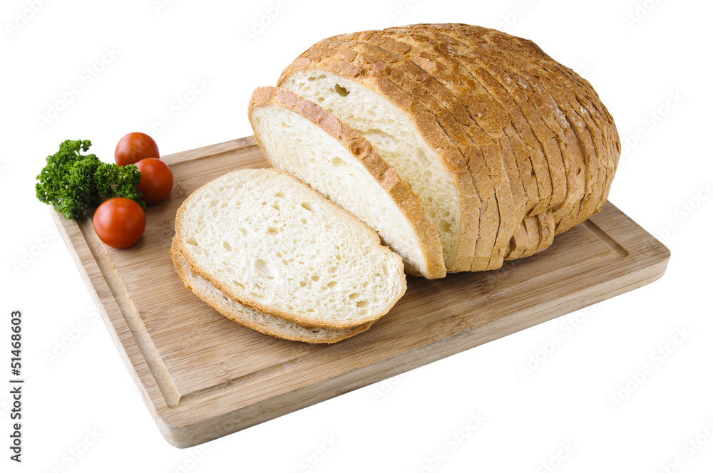 Cutted white bread on the wooden board with tomatos