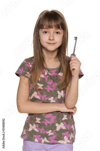 Young girl holds key in her hand